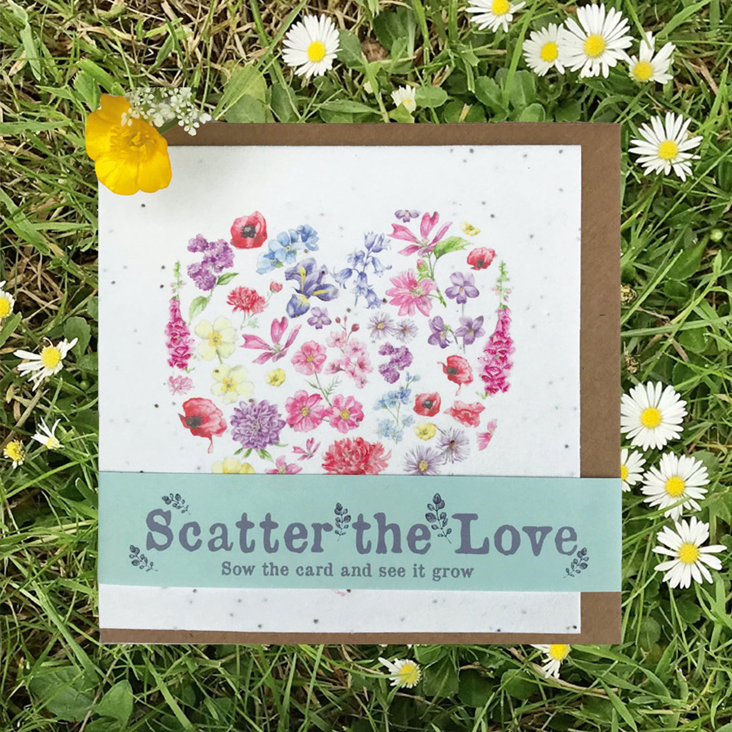 a card with a picture of a heart surrounded by daisies