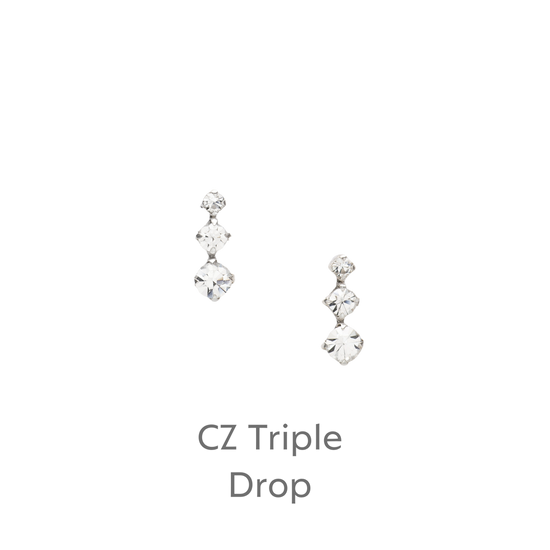 a pair of diamond earrings on a black background