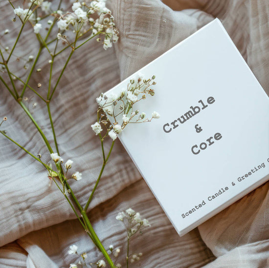 a box of crumble and core sitting on a bed