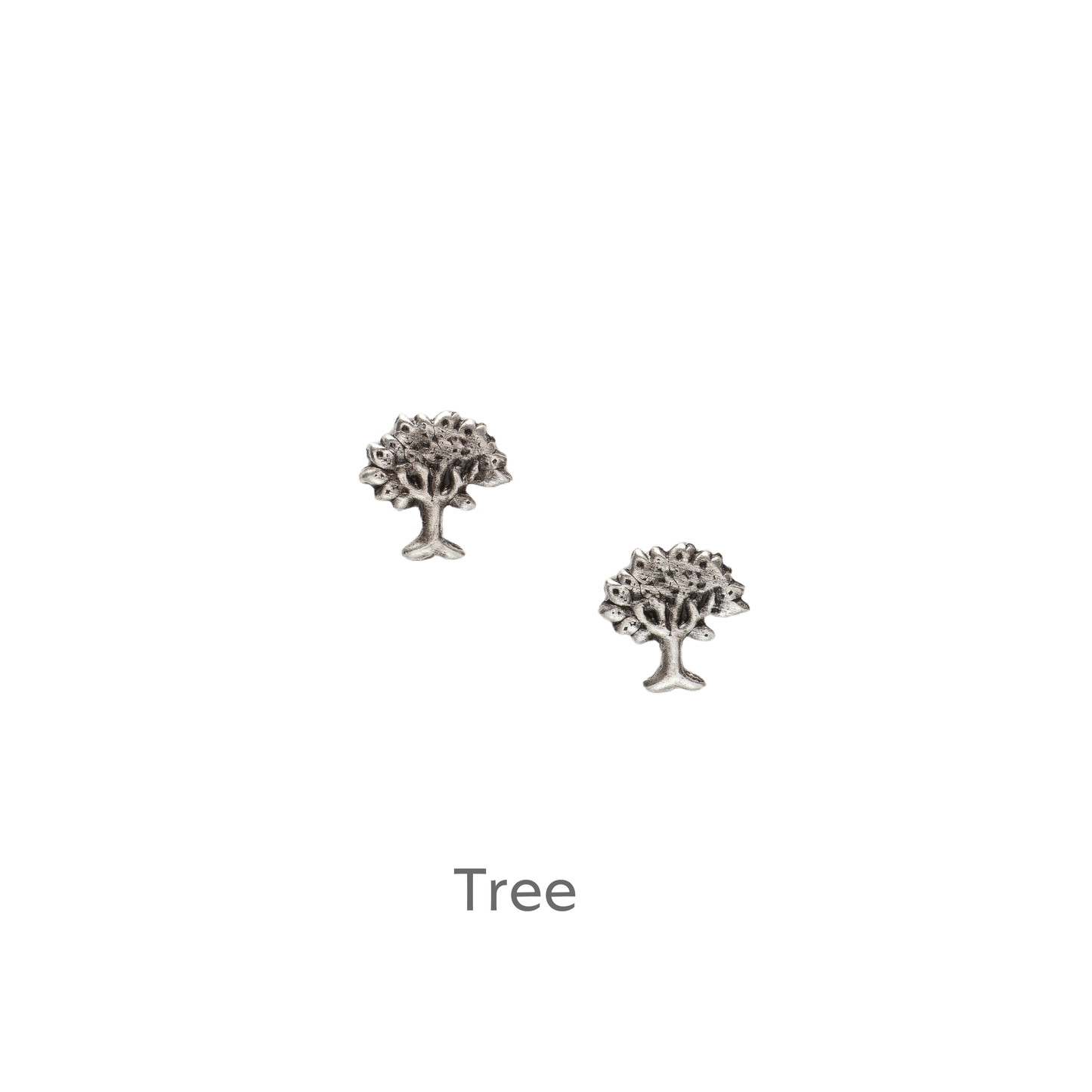 a pair of silver tree earrings on a black background