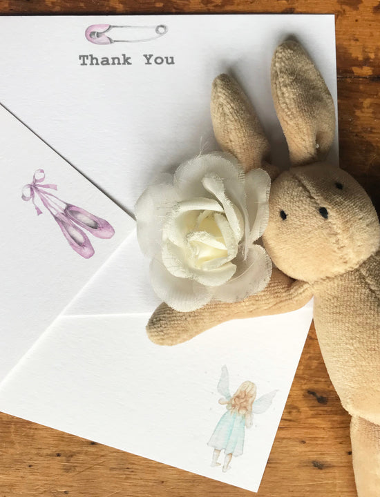 a stuffed animal next to a thank you card