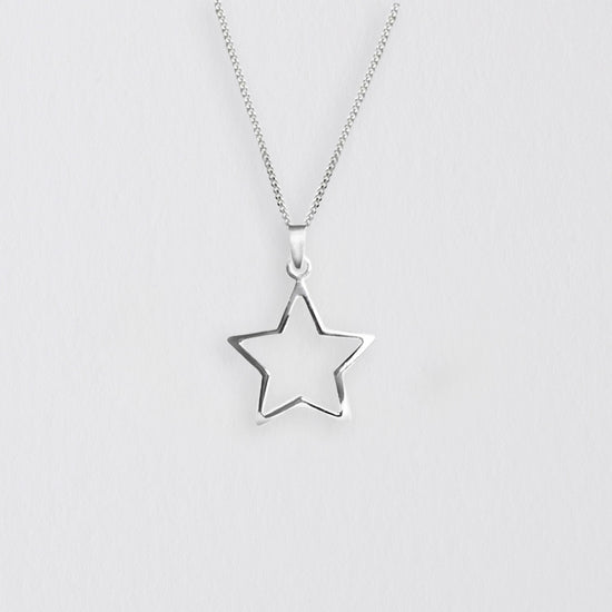 a silver necklace with a star on it