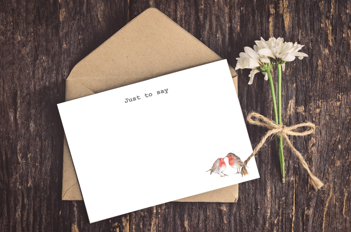 a card with a bird on it next to a flower