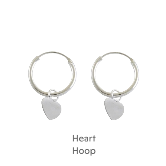 a pair of silver hoop earrings with a heart charm