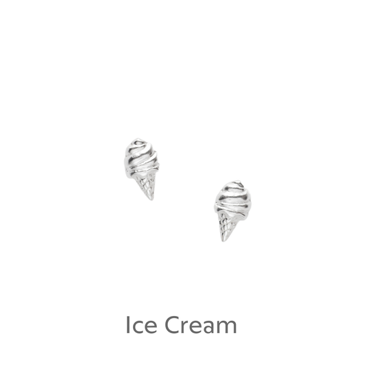 a pair of silver earrings on a black background