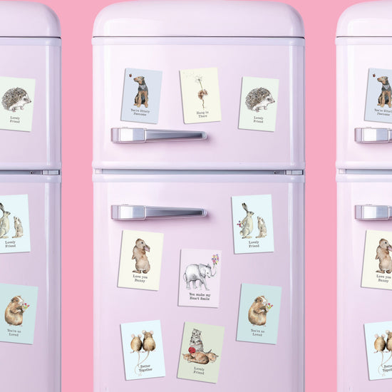 a pink refrigerator with magnets and pictures on it