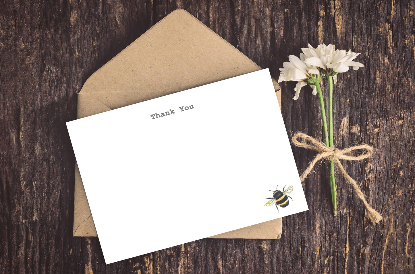 a card with a bee on it next to a flower