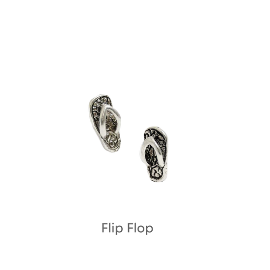 a pair of earrings on a black background