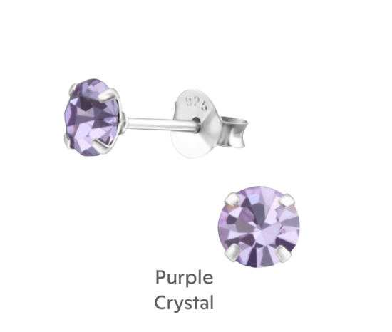 a pair of earrings with a purple stone