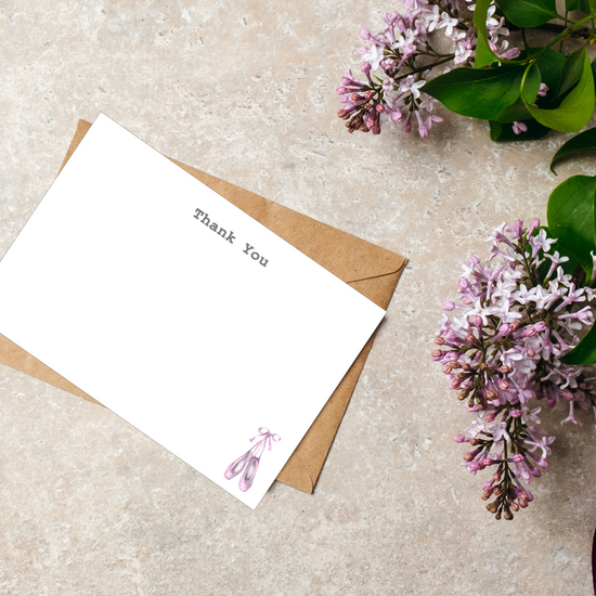 a note and some flowers on a table