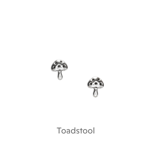 a pair of silver earrings on a black background