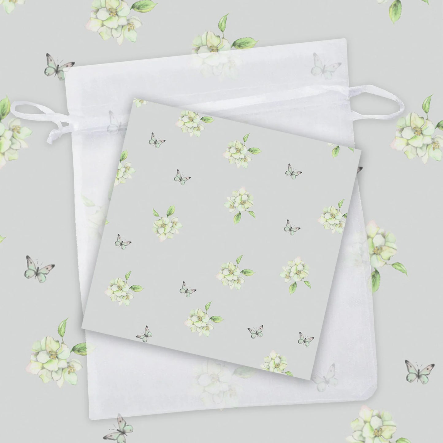 a repeating pattern of white flowers and butterflies on a light gray background.