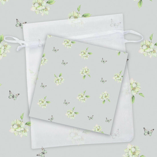 Load image into Gallery viewer, two napkins with white flowers on a gray background
