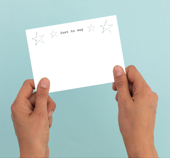 a person holding a card with stars on it