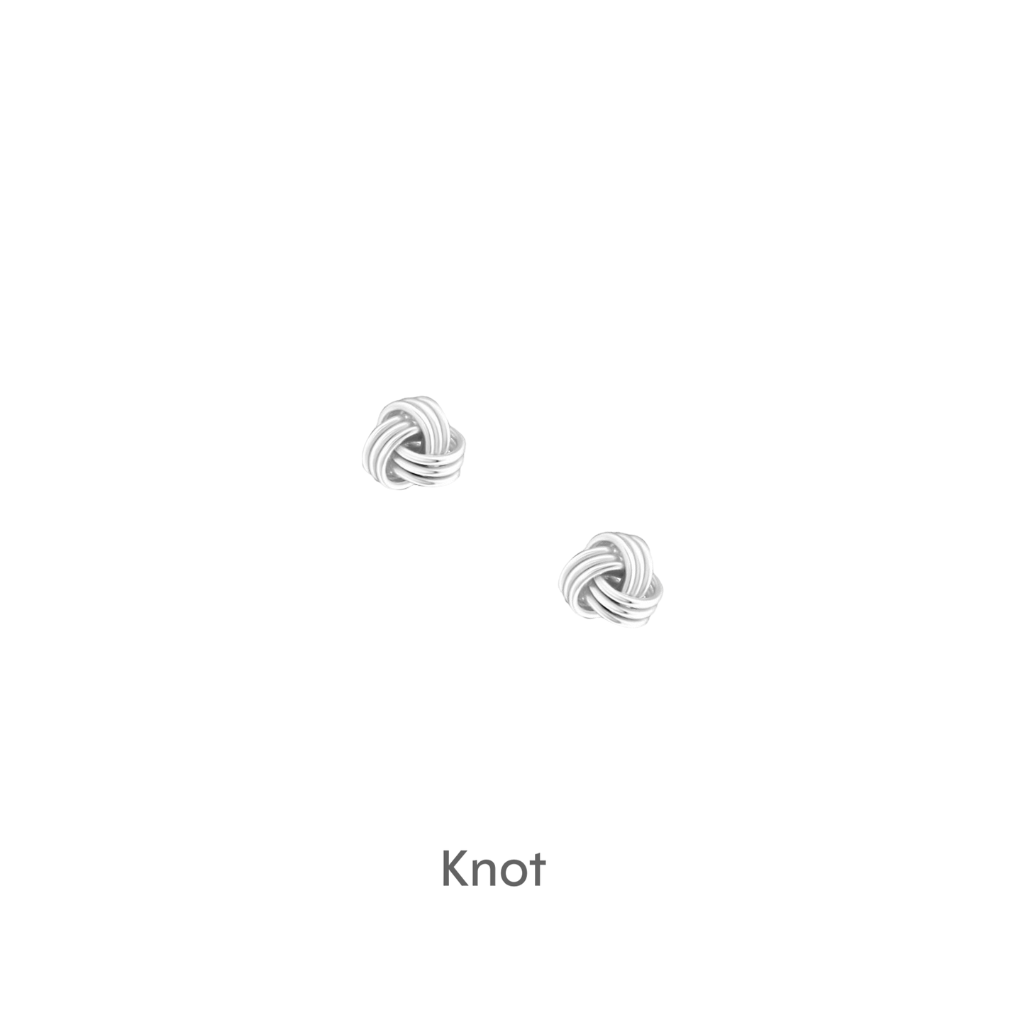 a pair of silver earrings on a black background