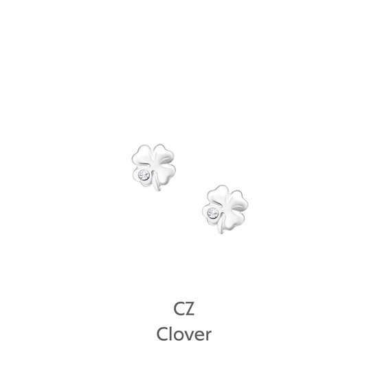 a pair of white flower earrings on a black background