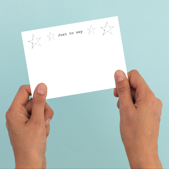 a person holding a card with stars on it