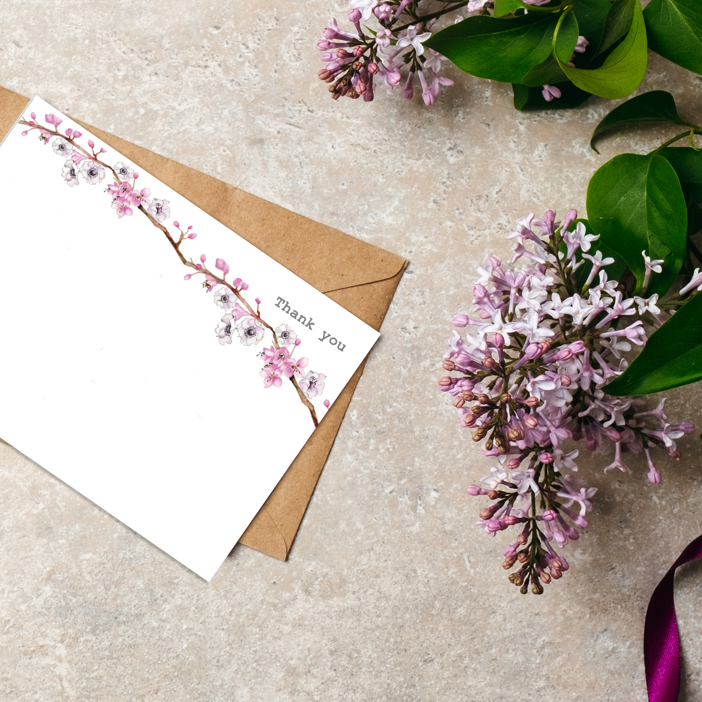 a card with flowers and a ribbon on a table